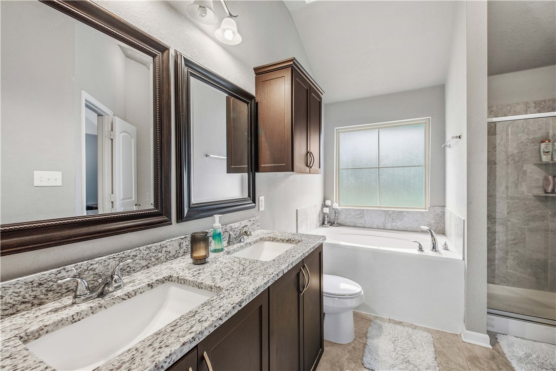3014 Positano Loop Bryan, TX 77808 - Photo 15 of 23 a bathroom with a granite countertop sink toilet and shower