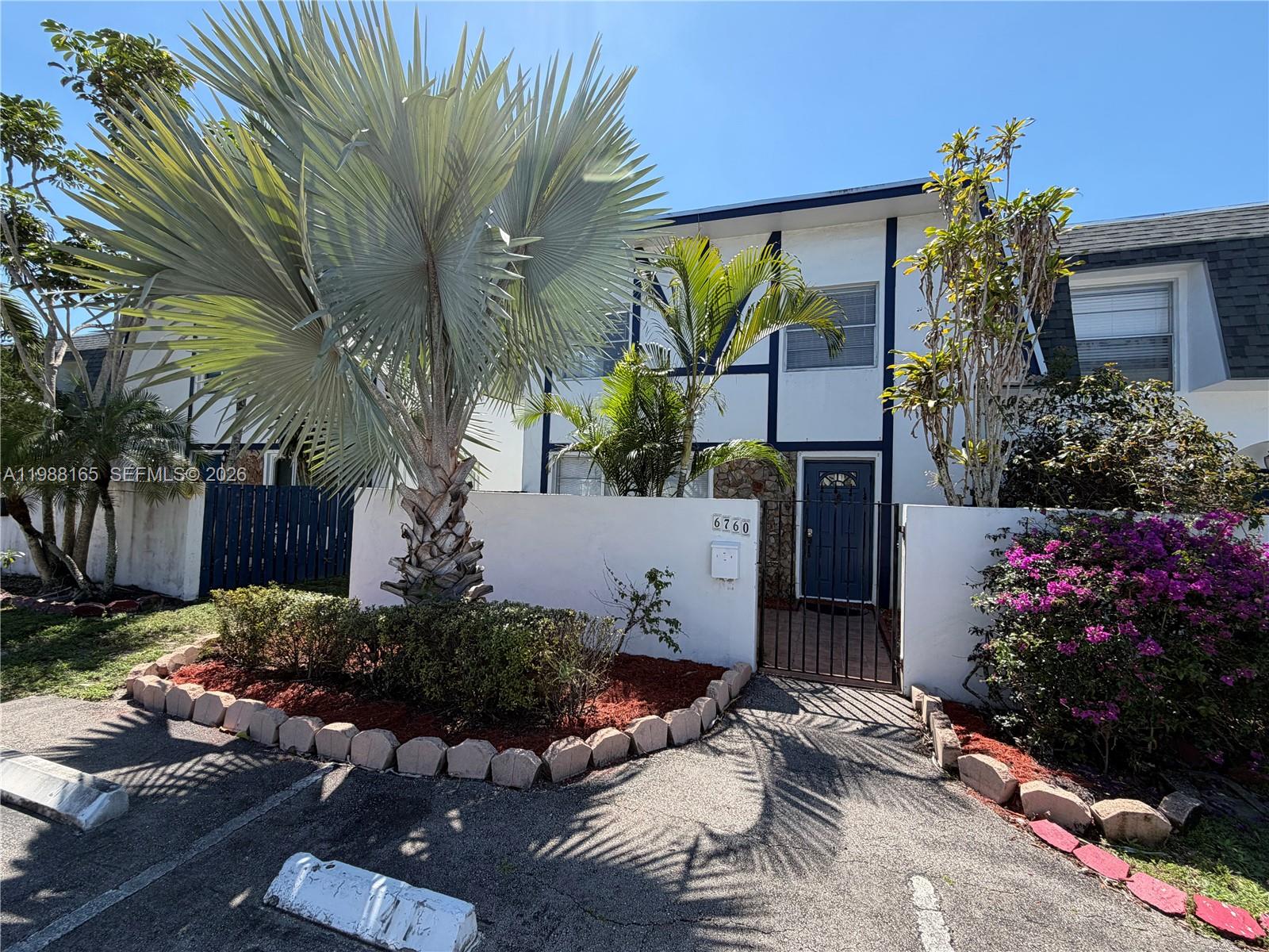 a view of backyard with plants and outdoor seating