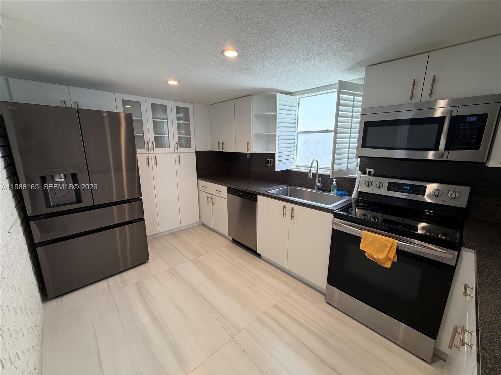 6760 Southwest 40th Street, Unit 41 Davie, FL 33314 - Photo 11 of 51 a kitchen with stainless steel appliances a stove a sink and a refrigerator