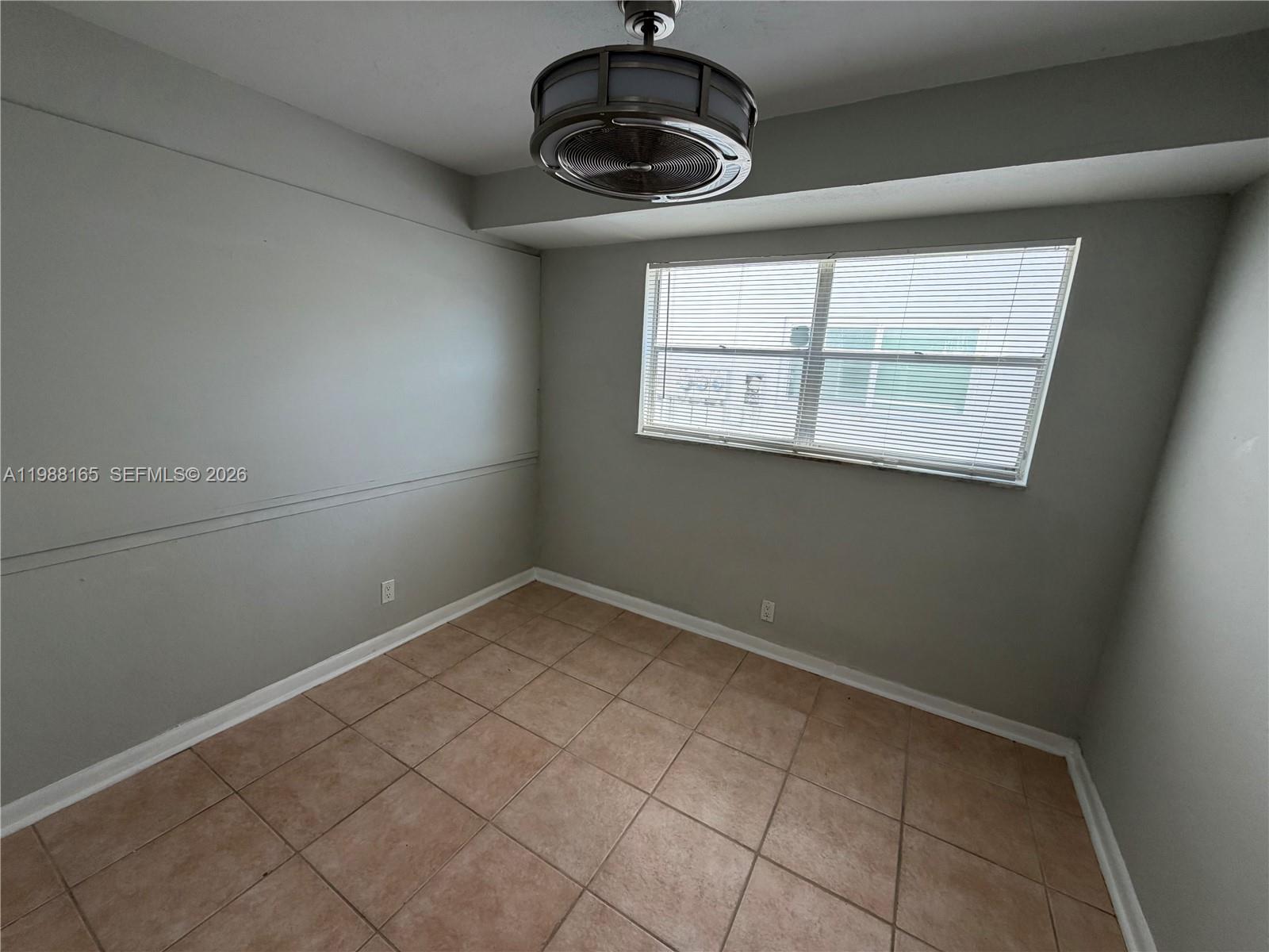 6760 Southwest 40th Street, Unit 41 Davie, FL 33314 - Photo 14 of 51 a view of a small space with wooden floor and windows