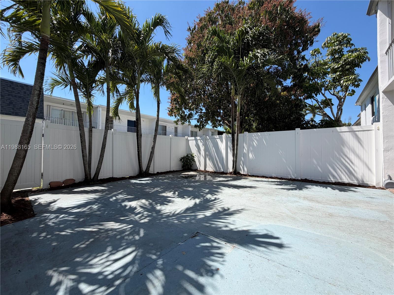 6760 Southwest 40th Street, Unit 41 Davie, FL 33314 - Photo 18 of 51 a view of wooden fence under a large tree
