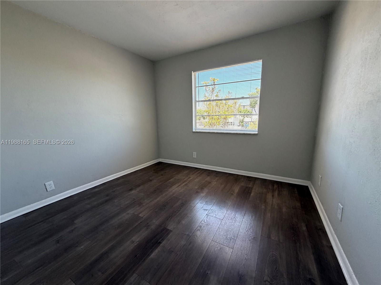 6760 Southwest 40th Street, Unit 41 Davie, FL 33314 - Photo 23 of 51 an empty room with wooden floor and windows