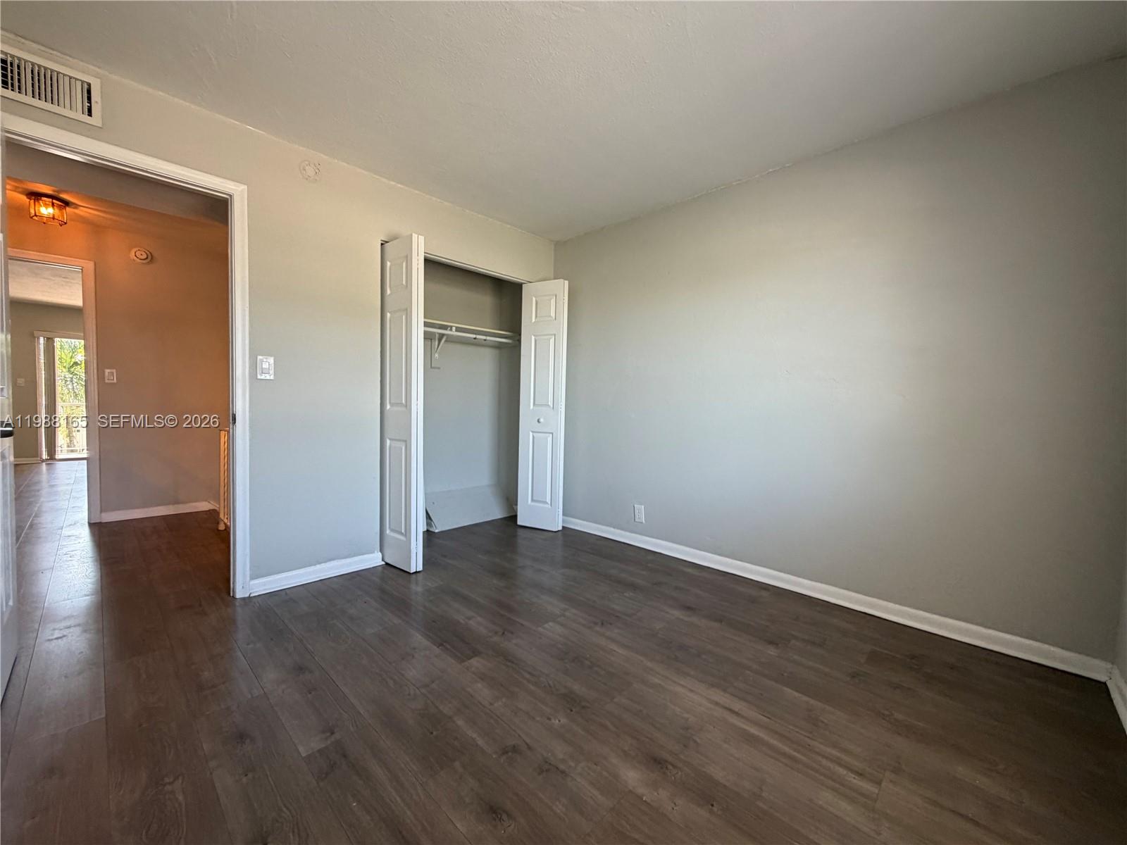 6760 Southwest 40th Street, Unit 41 Davie, FL 33314 - Photo 24 of 51 a view of an empty room with wooden floor and a window