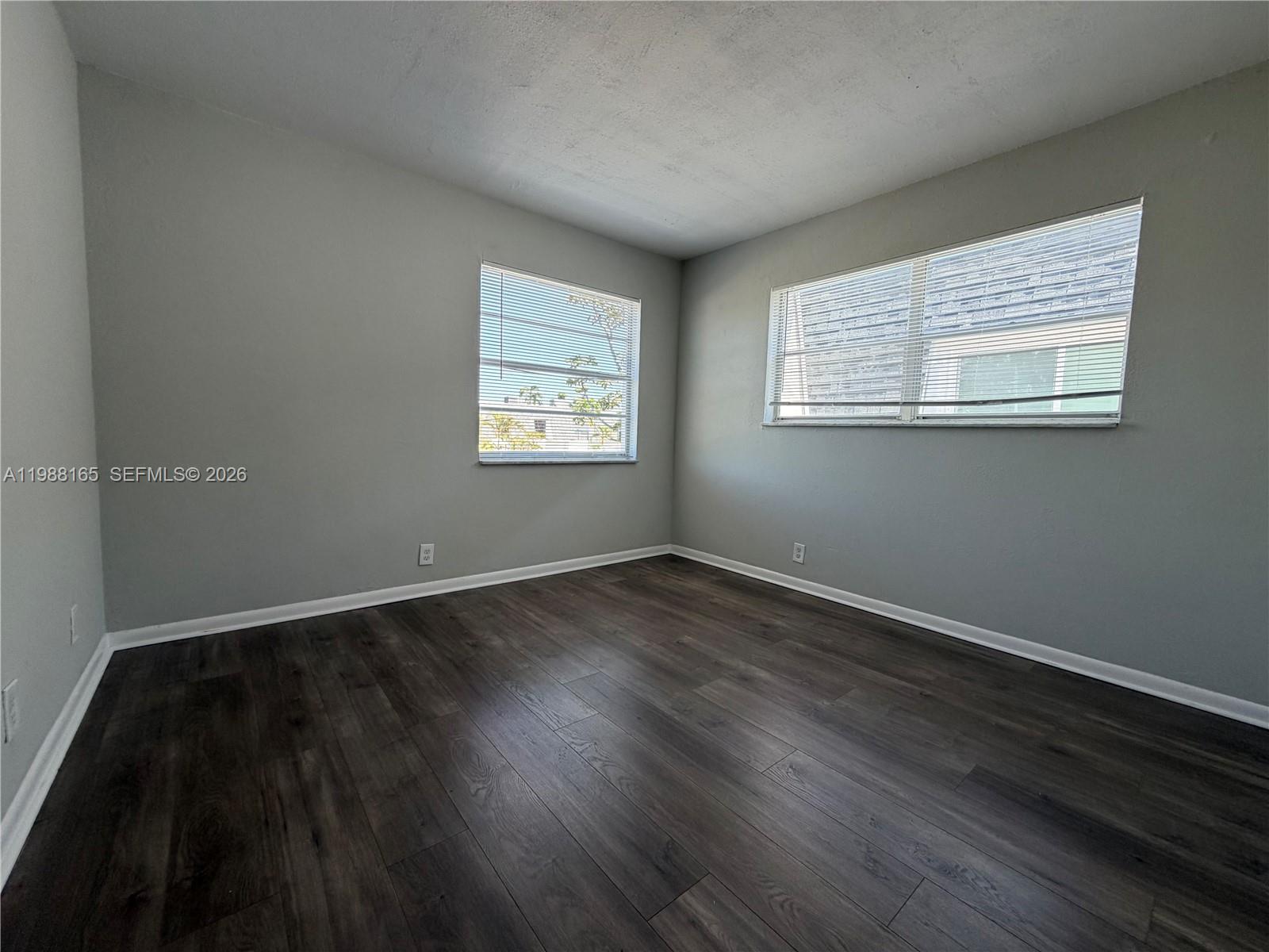 6760 Southwest 40th Street, Unit 41 Davie, FL 33314 - Photo 25 of 51 an empty room with wooden floor and windows