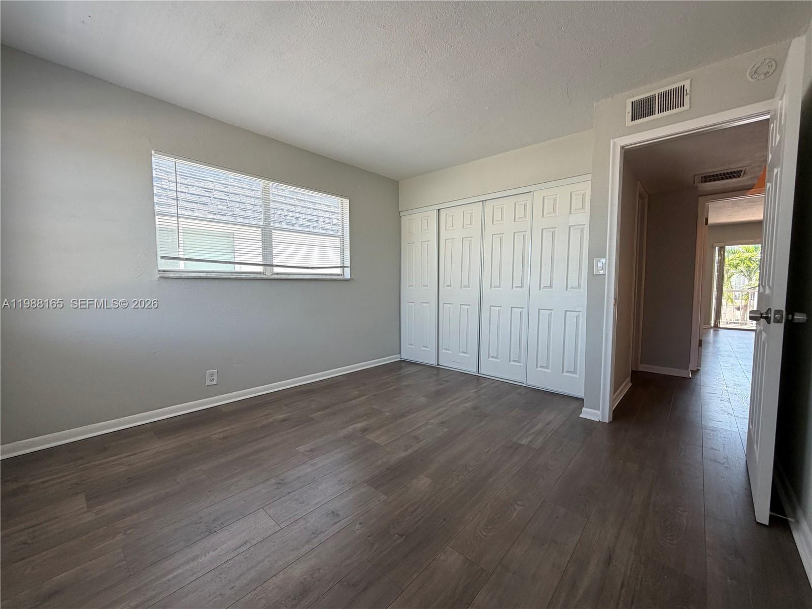 6760 Southwest 40th Street, Unit 41 Davie, FL 33314 - Photo 26 of 51 an empty room with wooden floor and windows