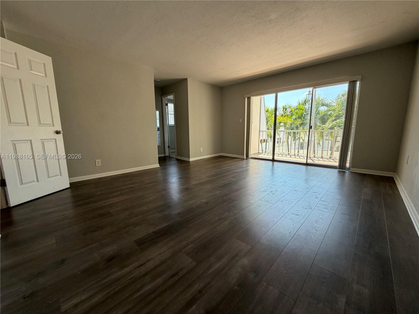 6760 Southwest 40th Street, Unit 41 Davie, FL 33314 - Photo 28 of 51 a view of an empty room with wooden floor and a window