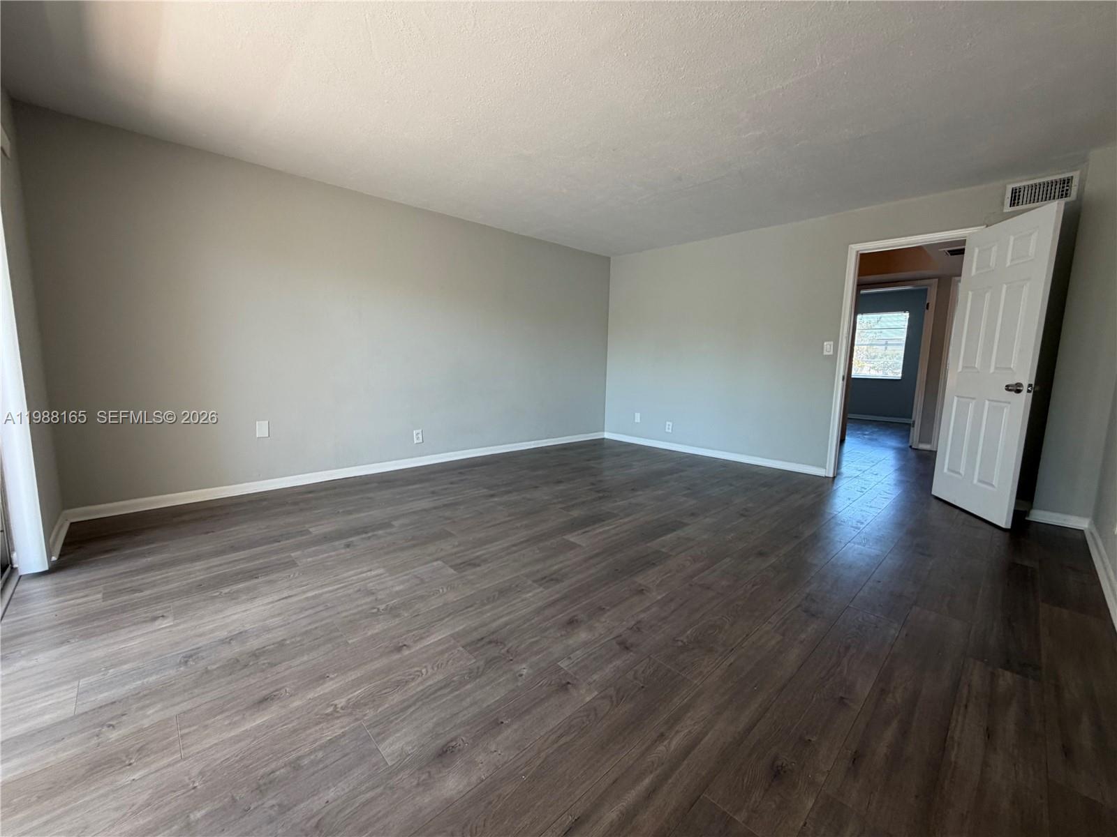 6760 Southwest 40th Street, Unit 41 Davie, FL 33314 - Photo 29 of 51 a view of an empty room with wooden floor and a window