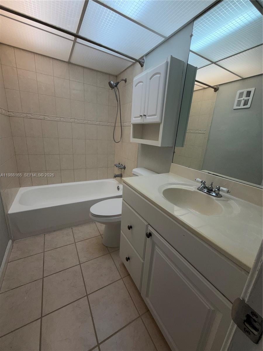 6760 Southwest 40th Street, Unit 41 Davie, FL 33314 - Photo 38 of 51 a bathroom with a granite countertop sink a toilet and shower