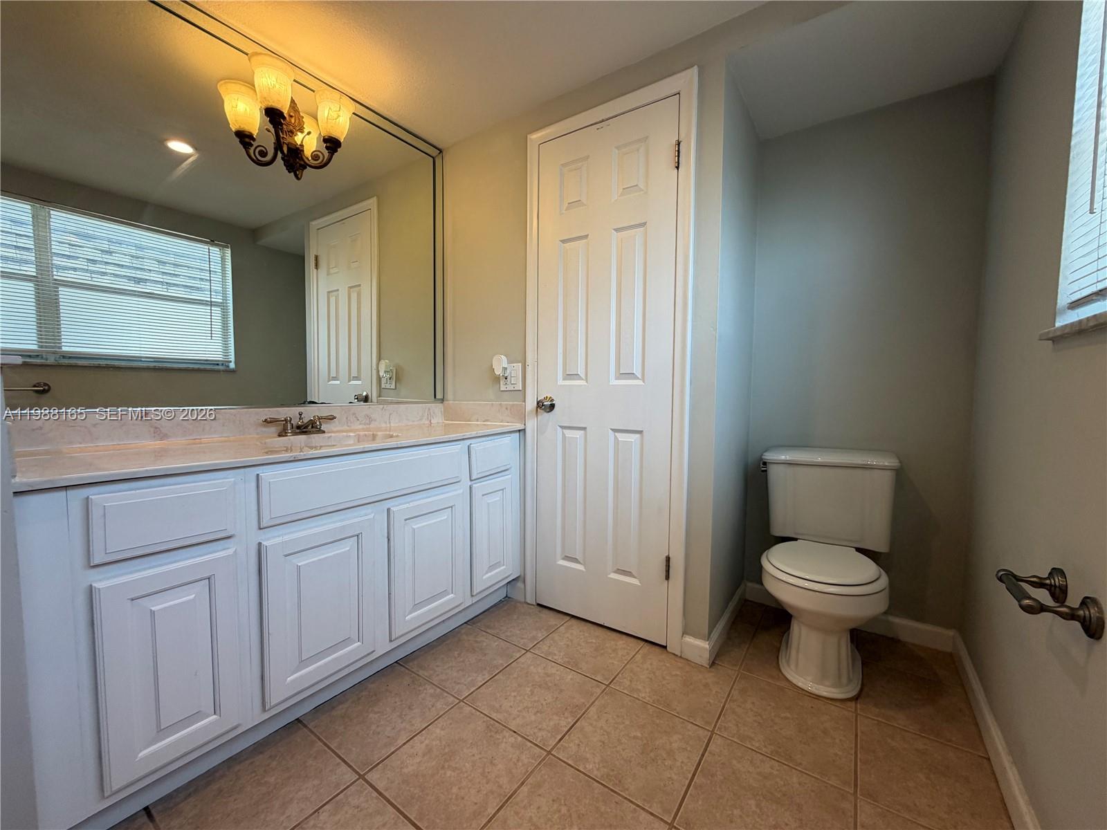6760 Southwest 40th Street, Unit 41 Davie, FL 33314 - Photo 39 of 51 a bathroom with a toilet sink and mirror