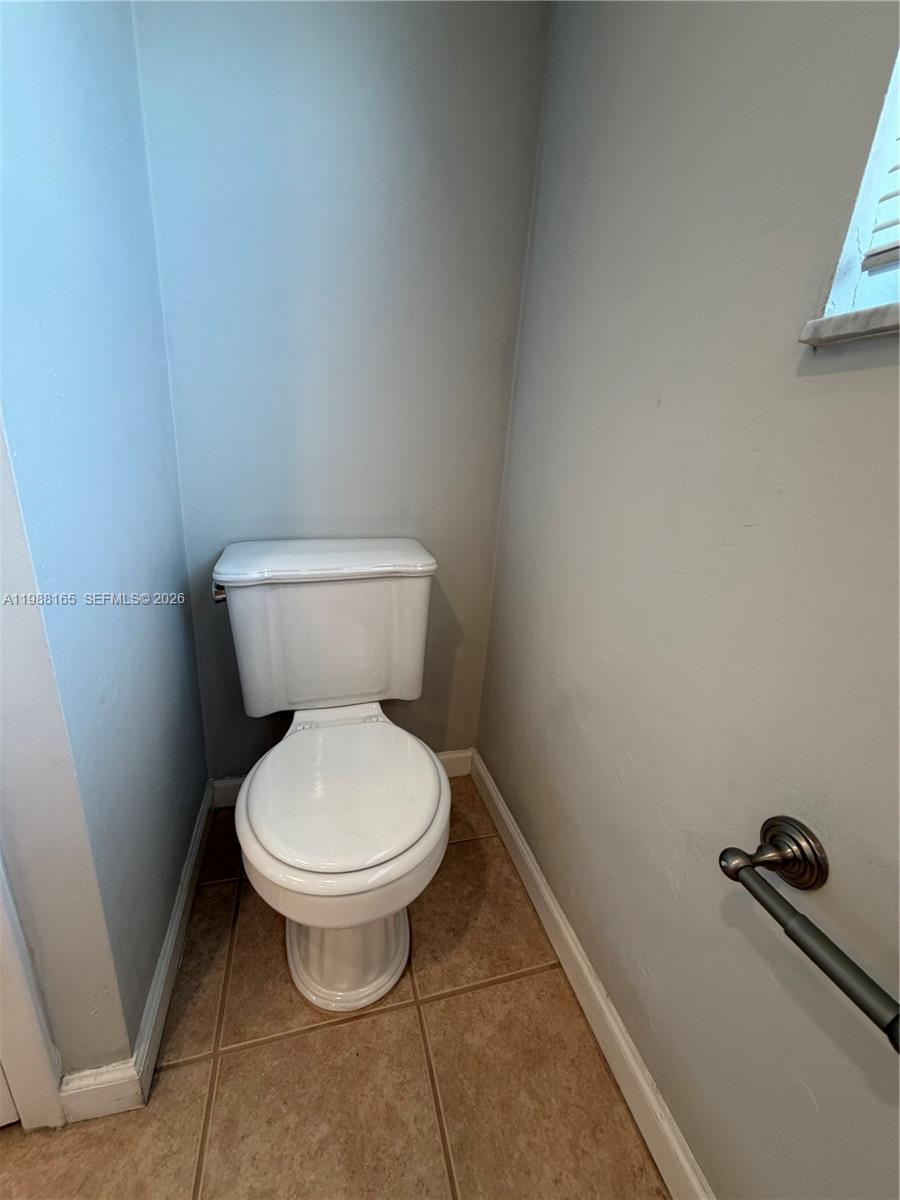 6760 Southwest 40th Street, Unit 41 Davie, FL 33314 - Photo 45 of 51 a white toilet sitting in a bathroom next to a sink