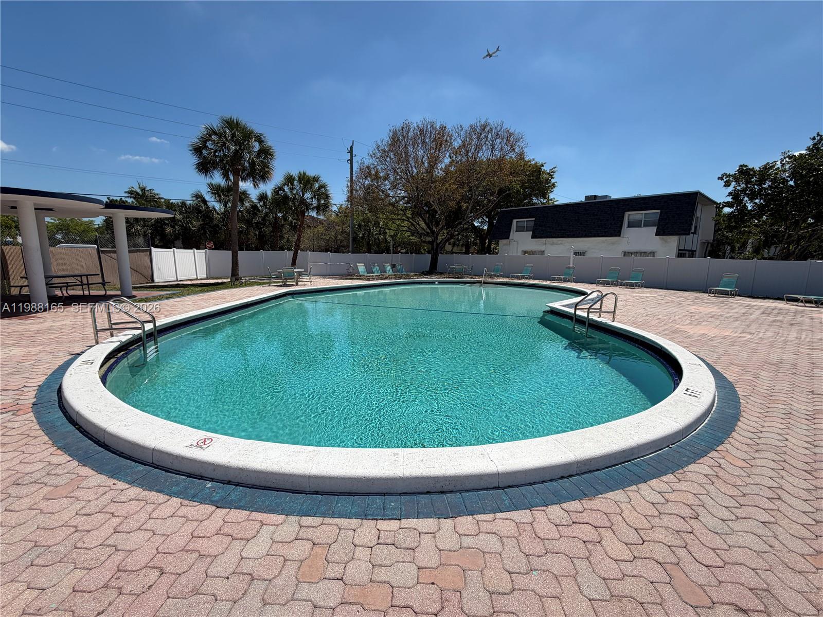 6760 Southwest 40th Street, Unit 41 Davie, FL 33314 - Photo 47 of 51 a view of a swimming pool with a yard