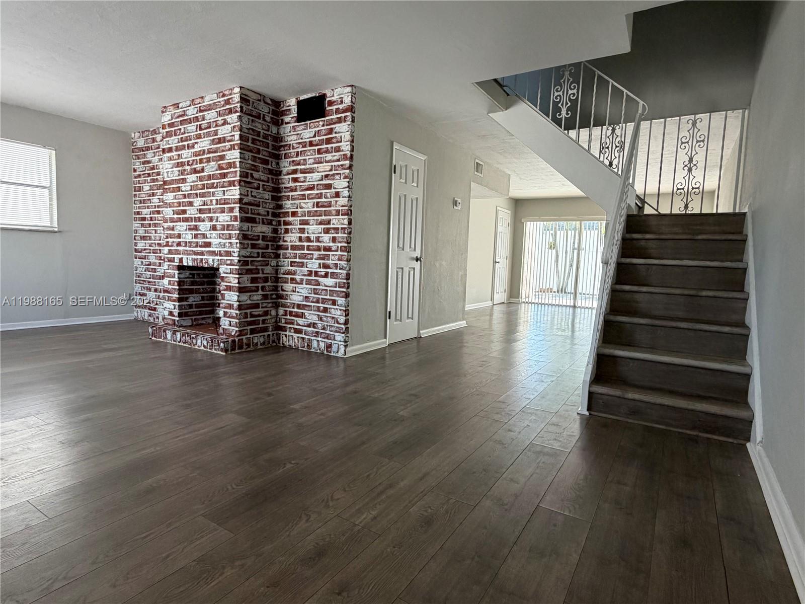 6760 Southwest 40th Street, Unit 41 Davie, FL 33314 - Photo 8 of 51 an empty room with stairs and wooden floor
