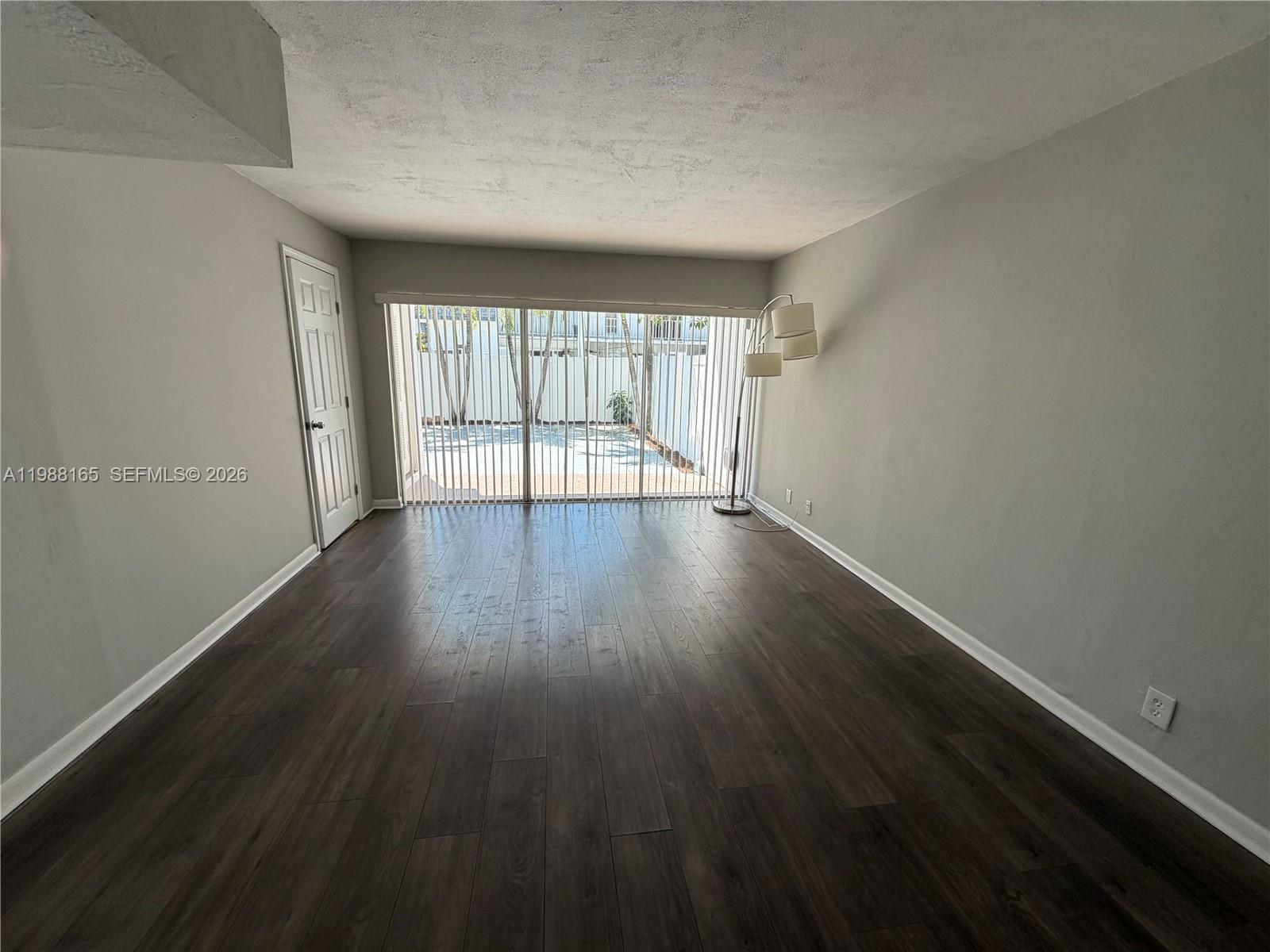 6760 Southwest 40th Street, Unit 41 Davie, FL 33314 - Photo 10 of 51 a view of an empty room with wooden floor and a window