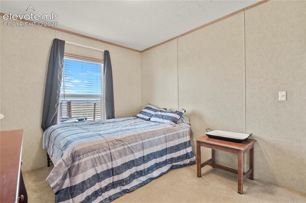 22280 Jones Road Peyton, CO 80831 - Photo 28 of 47 a bedroom with a bed and a window