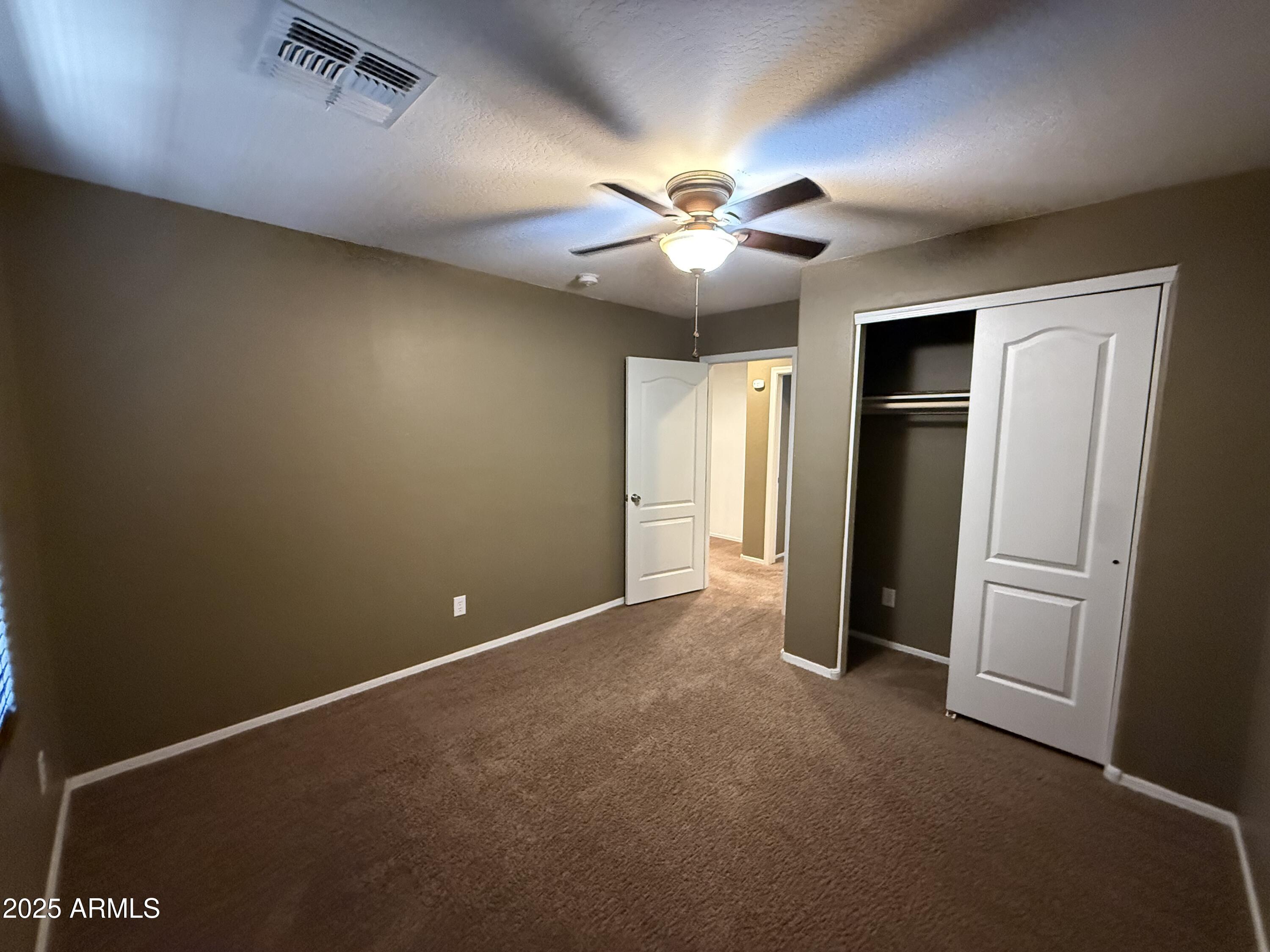3511 East Tulsa Street Gilbert, AZ 85295 - Photo 21 of 30 an empty room with closet and a ceiling fan