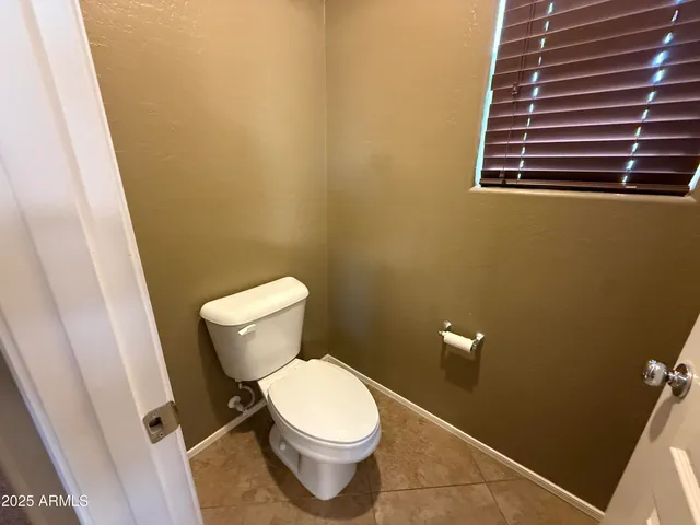 a white toilet sitting next to a small sink