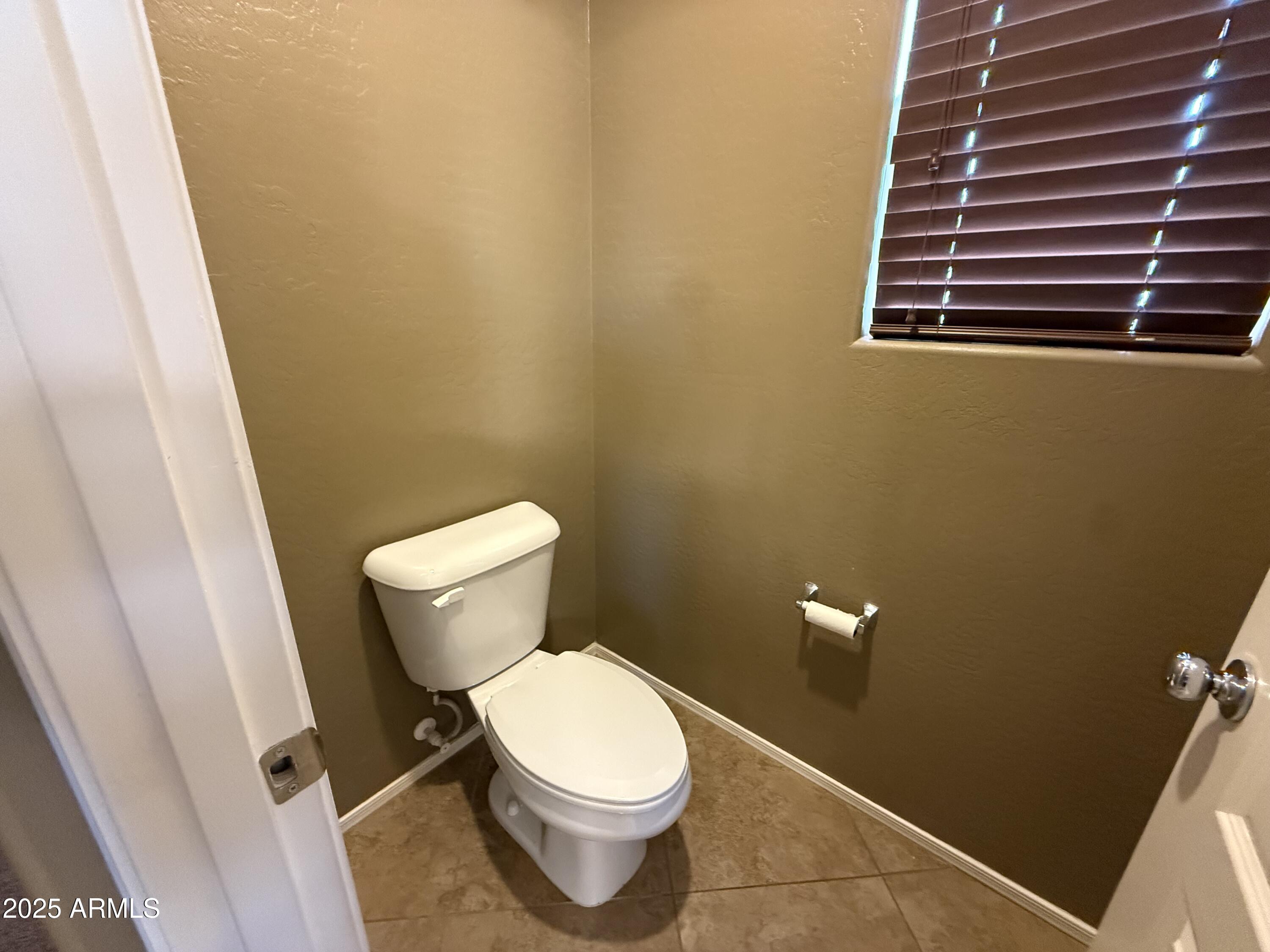3511 East Tulsa Street Gilbert, AZ 85295 - Photo 24 of 30 a white toilet sitting next to a small sink