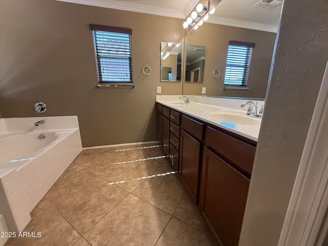 a spacious bathroom with a bathtub sink and mirror
