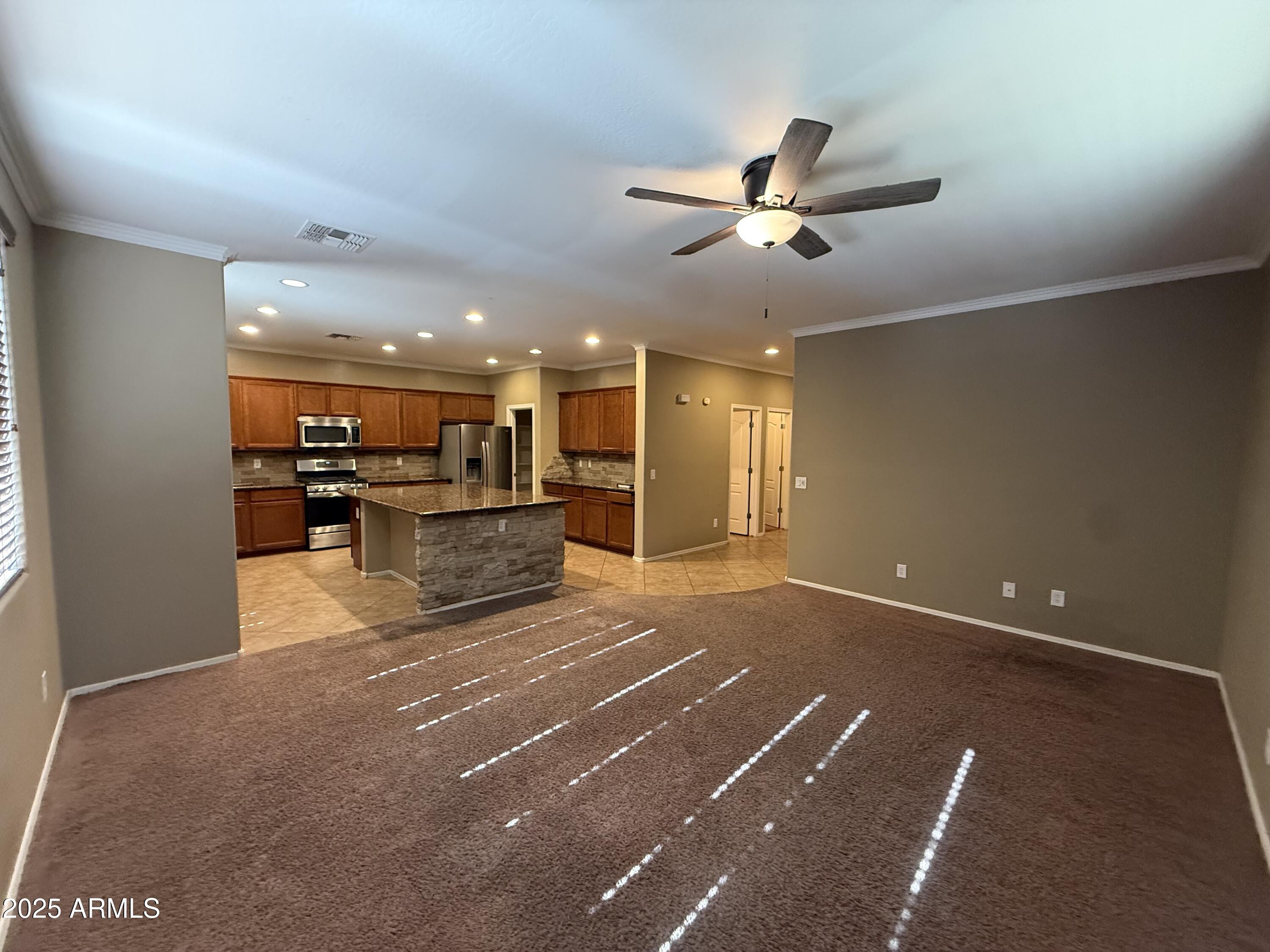 3511 East Tulsa Street Gilbert, AZ 85295 - Photo 8 of 30 a view of a kitchen with a sink and stainless steel appliances