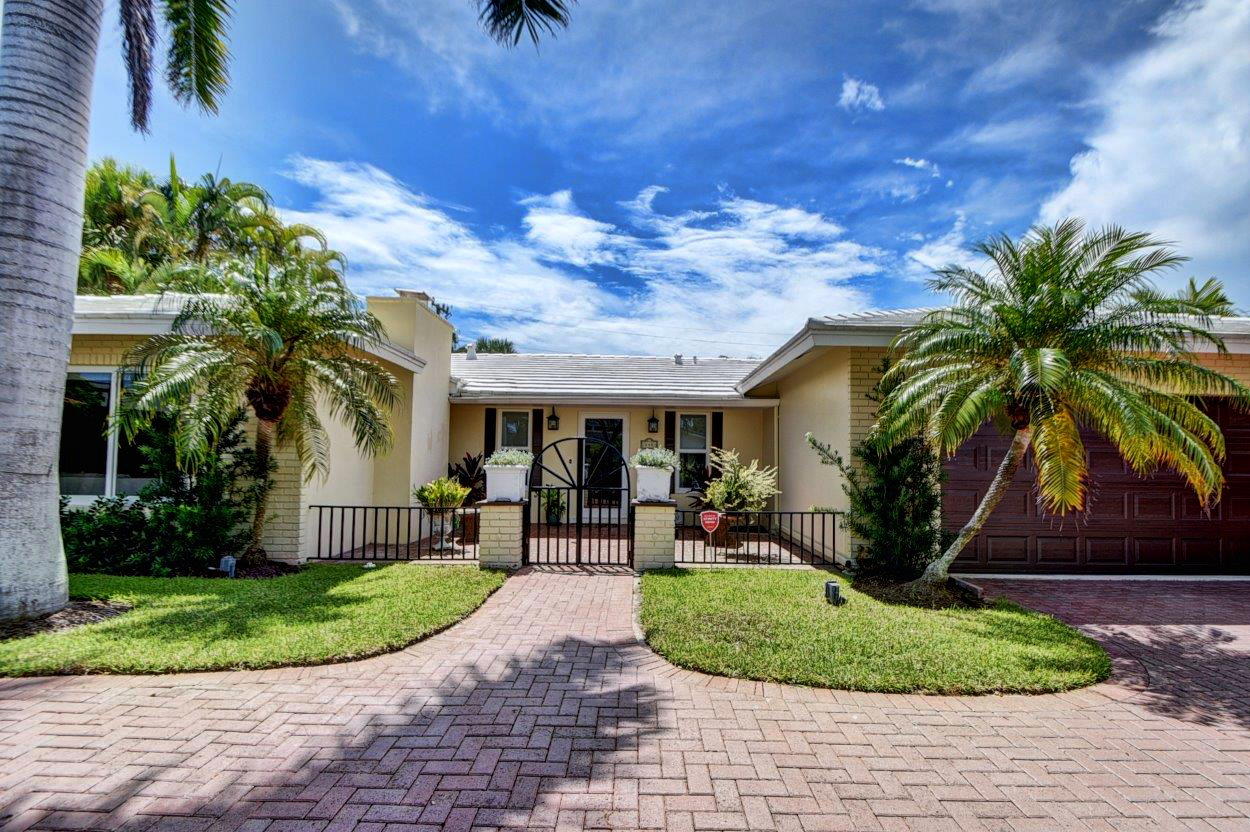 840 Granada Drive Boca Raton, FL 33432 - Photo 1 of 1 a front view of a house with garden and plants