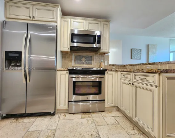 a kitchen with granite countertop a stainless steel appliances and cabinets
