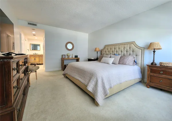 a bedroom with a bed and a lamp on table