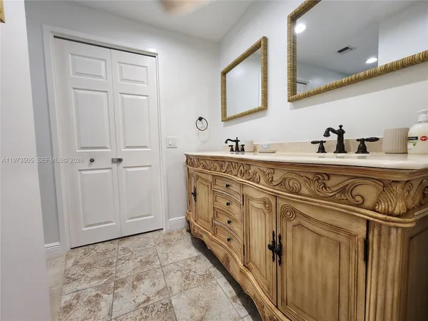 a bathroom with a sink a vanity and a mirror