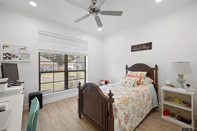 a bedroom with a bed and a large window