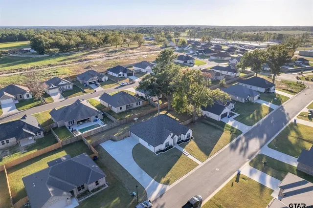 an aerial view of residential houses with outdoor space