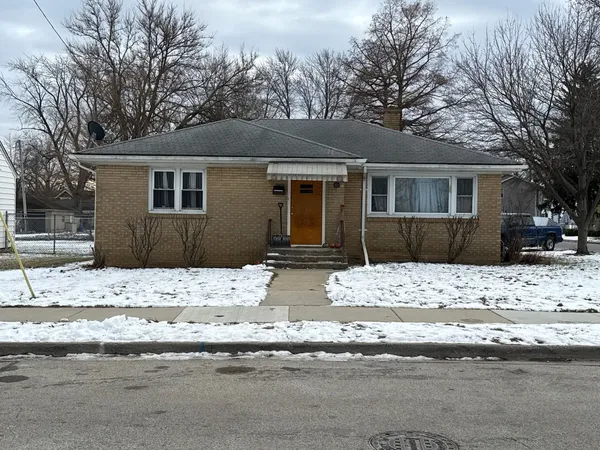 a view of a house with a yard covered in snow