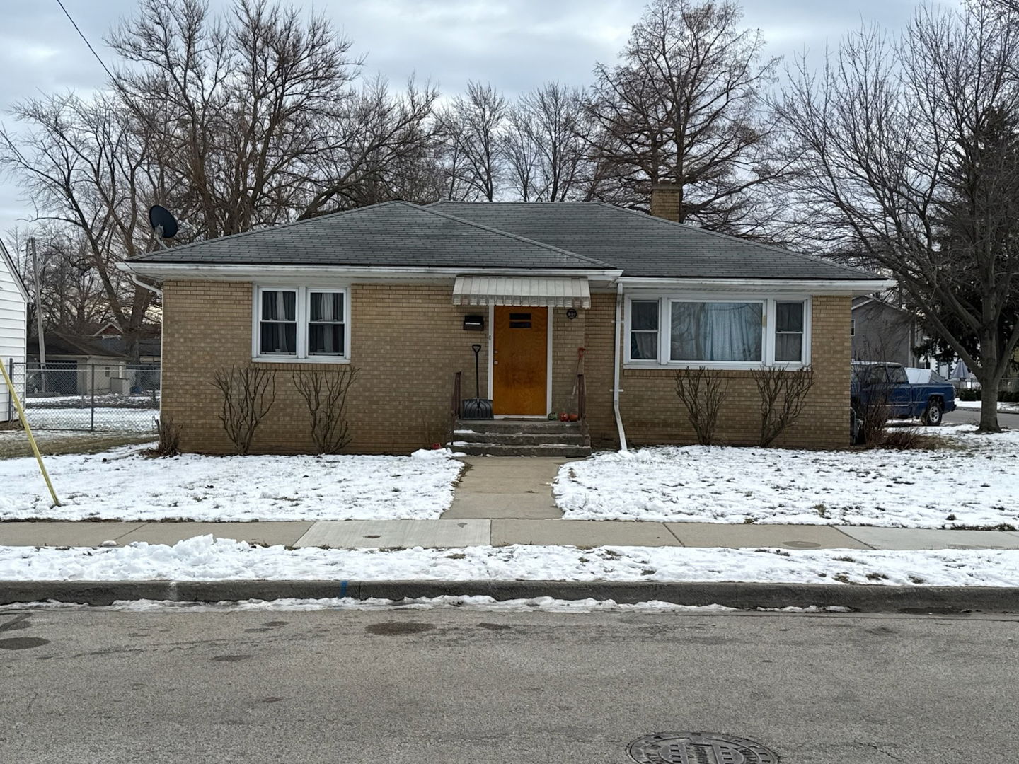 601 East 10th Street Lockport, IL 60441 - Photo 1 of 11 a view of a house with a yard covered in snow