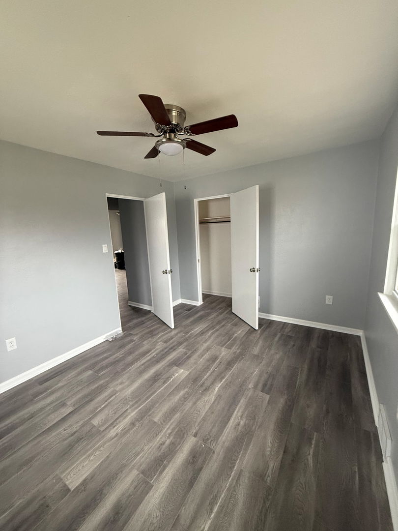 601 East 10th Street Lockport, IL 60441 - Photo 3 of 11 a view of empty room with wooden floor and fan