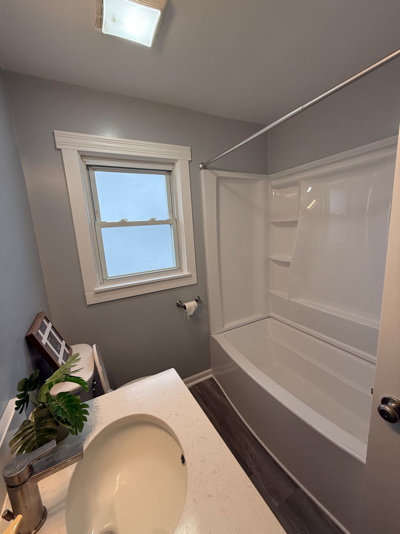 601 East 10th Street Lockport, IL 60441 - Photo 8 of 11 a bathroom with a sink and a mirror