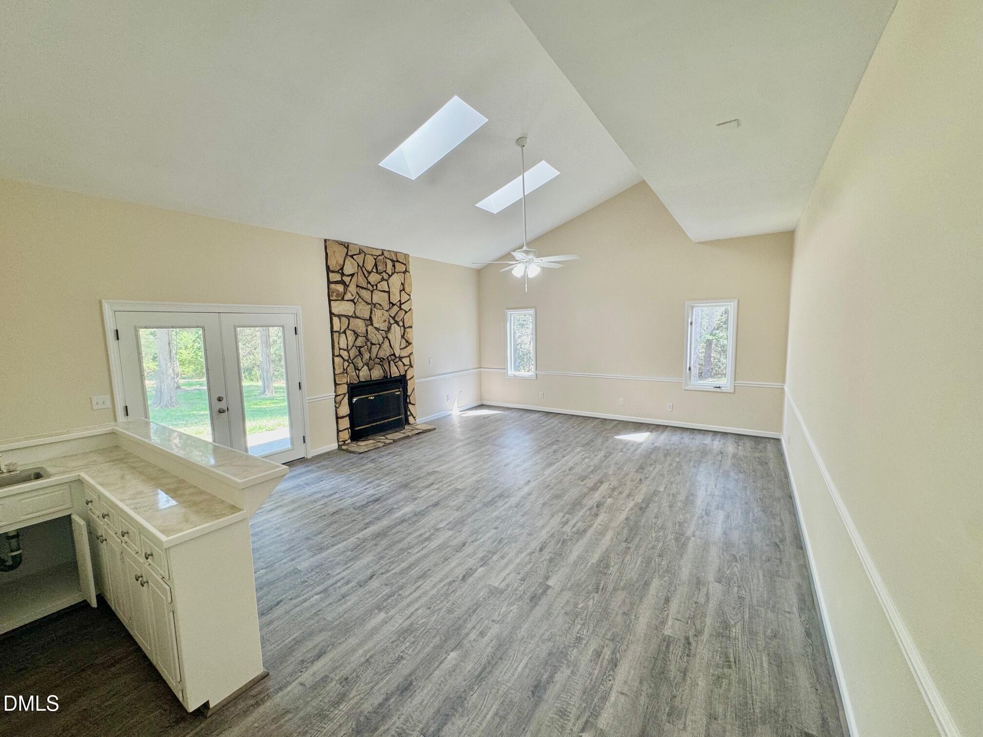 1720 Ross Mill Road Henderson, NC 27537 - Photo 11 of 42 a view of an empty room with a window and wooden floor