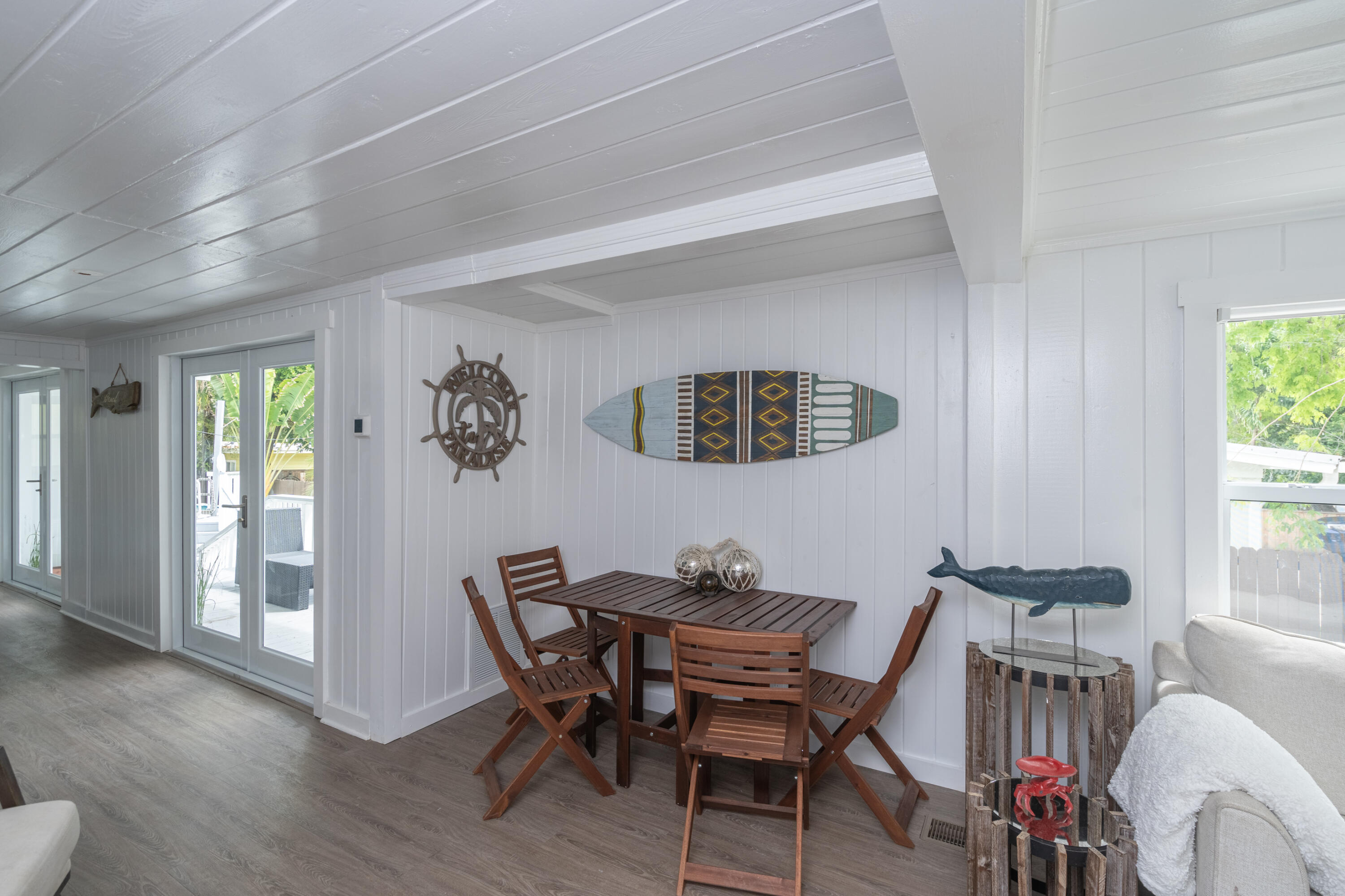 124 South Bay Harbor Drive Key Largo, FL 33037 - Photo 12 of 28 a view of a dining room with furniture window and wooden floor