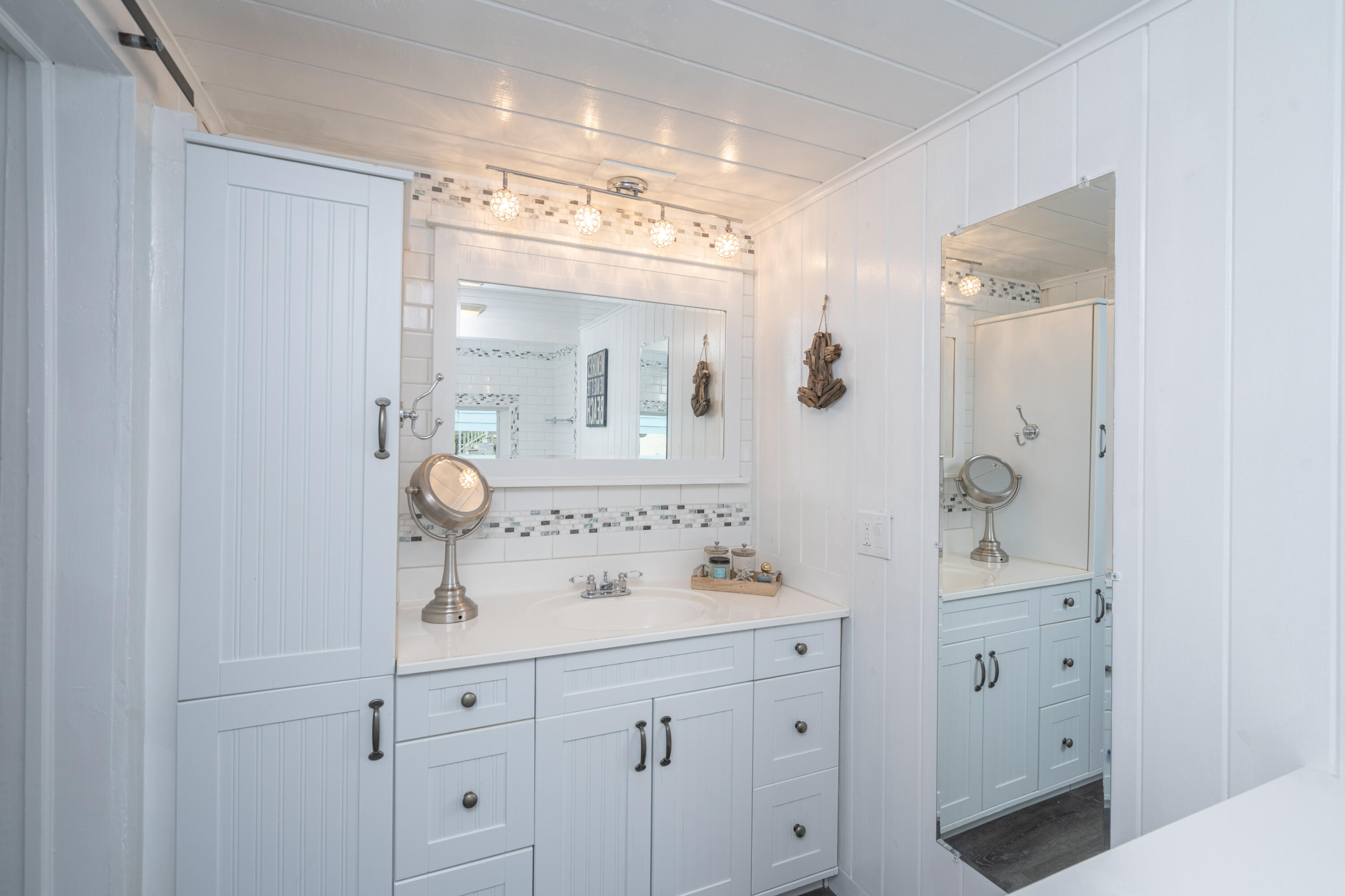 124 South Bay Harbor Drive Key Largo, FL 33037 - Photo 15 of 28 a bathroom with a sink vanity and mirror