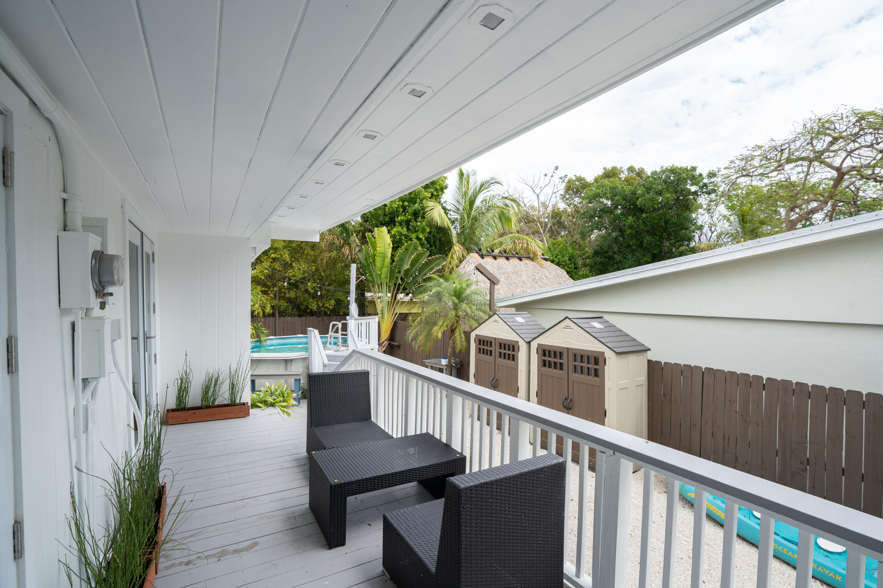 124 South Bay Harbor Drive Key Largo, FL 33037 - Photo 21 of 28 a view of a balcony with chairs and wooden fence