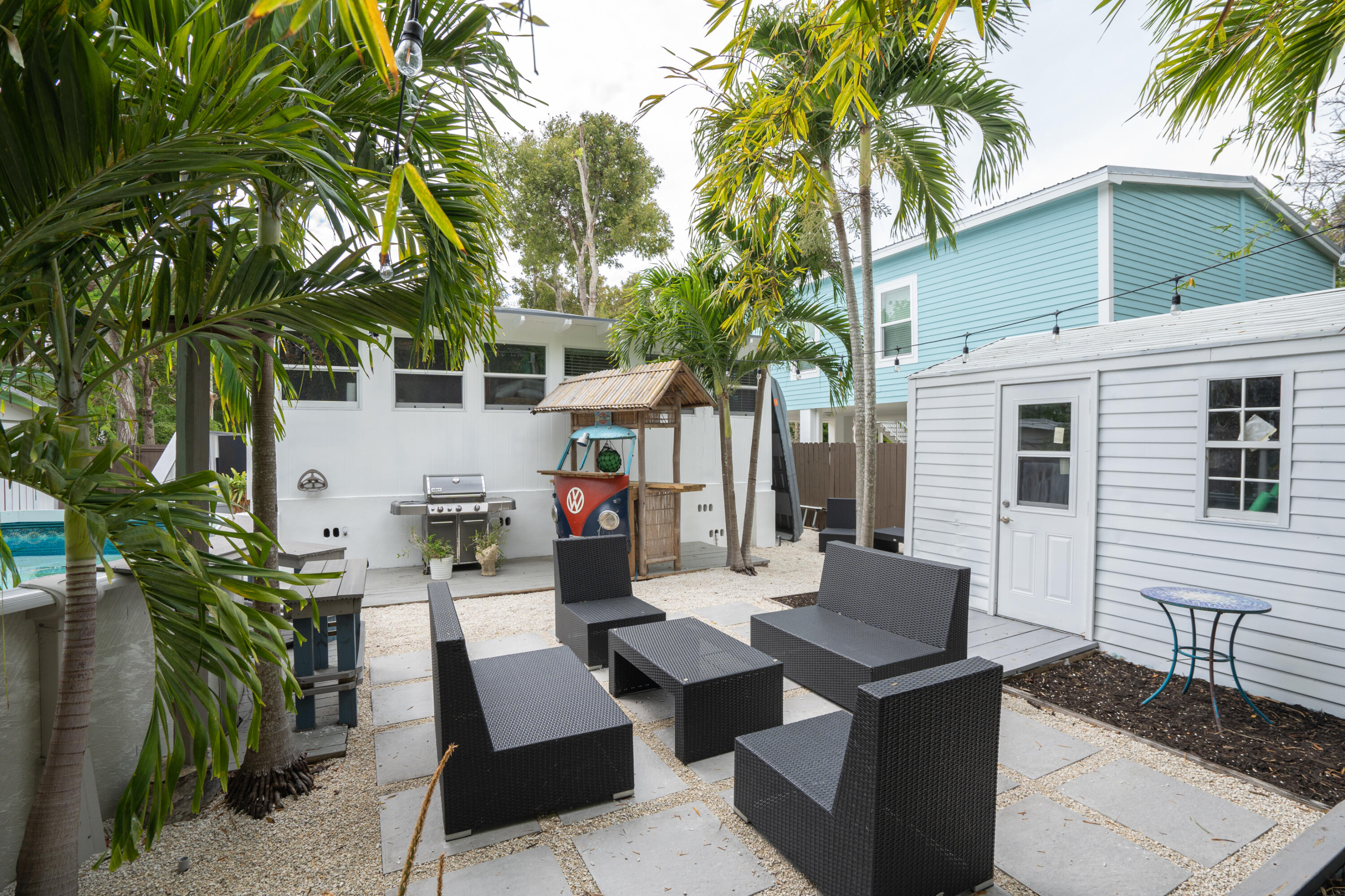124 South Bay Harbor Drive Key Largo, FL 33037 - Photo 24 of 28 a backyard of a house with table and chairs