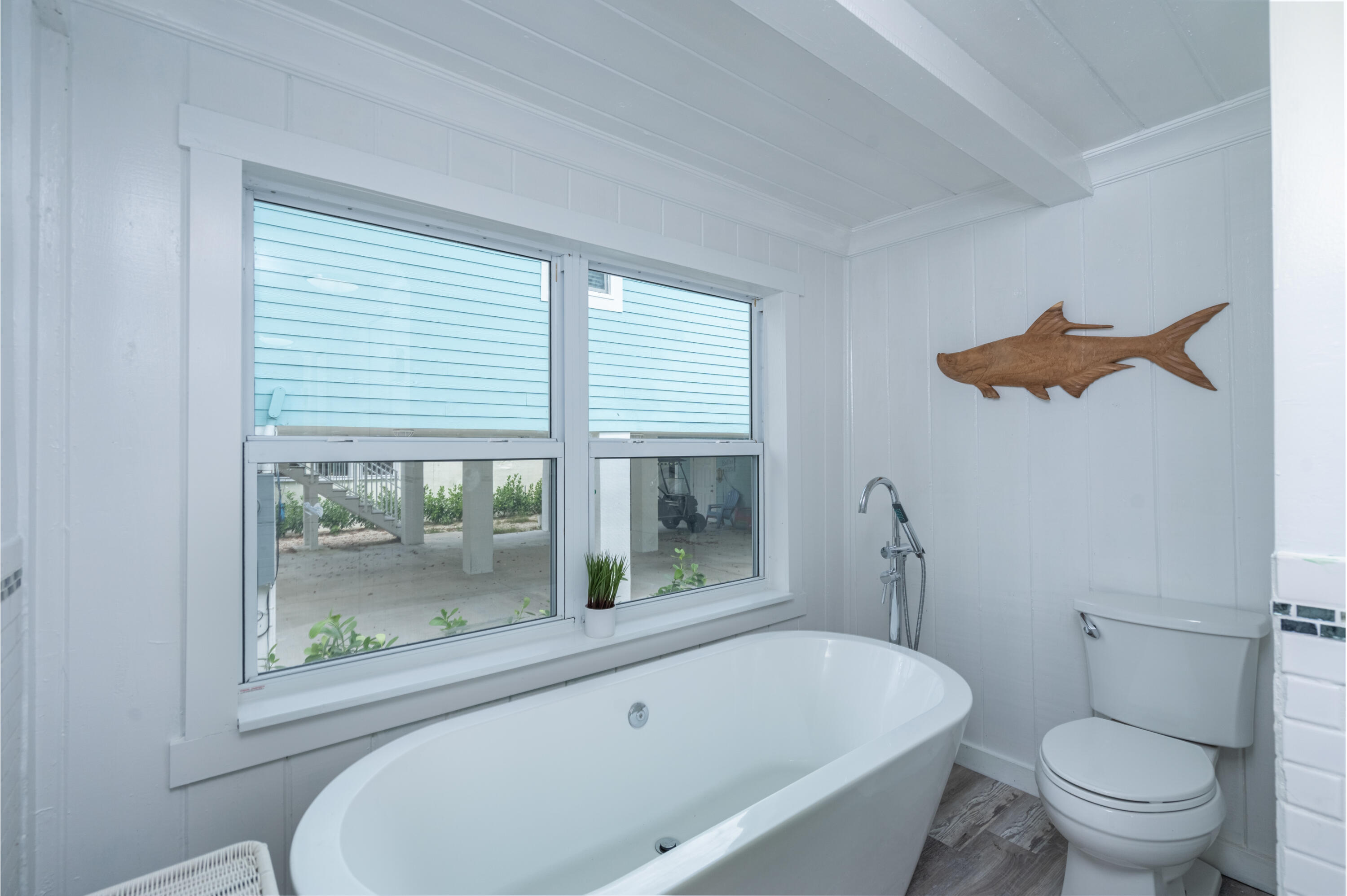 124 South Bay Harbor Drive Key Largo, FL 33037 - Photo 8 of 28 a bathroom with a toilet and a large window
