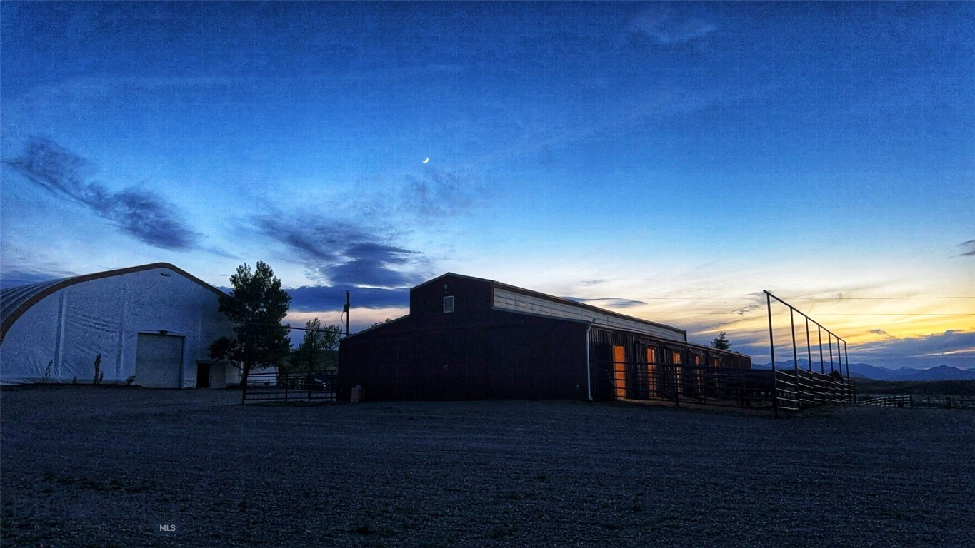 600 Blue Ribbon Lane Dillon, MT 59725 - Photo 39 of 65 Main Barn and Indoor Arena at Night