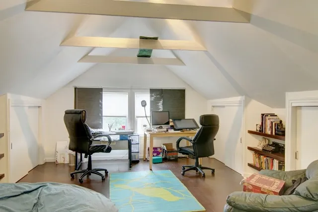 a view of a livingroom with workspace and a couch