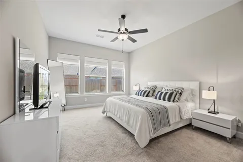 a spacious bedroom with a bed and a large window