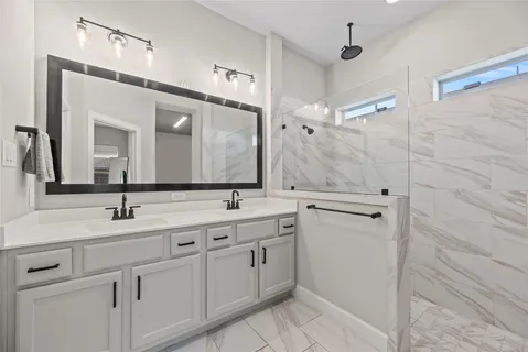 a bathroom with a double vanity sink and mirror
