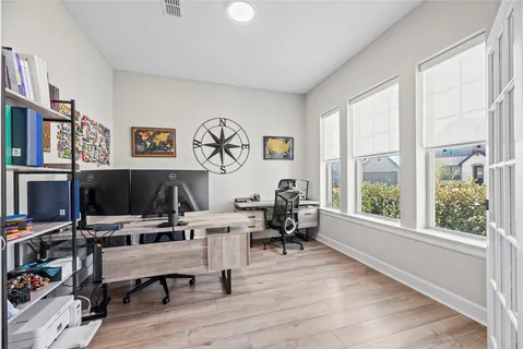 a view of a workspace with furniture and a window