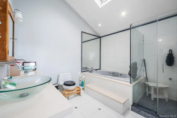 a bathroom with a tub sink and mirror