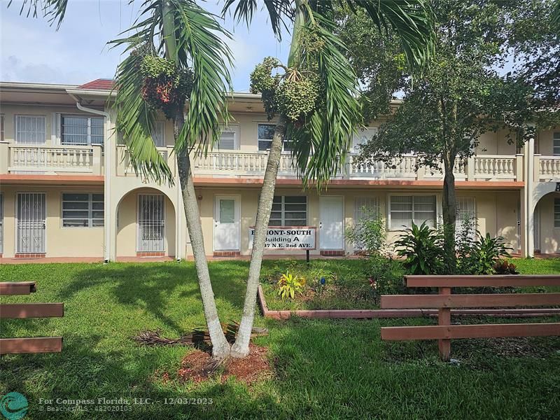 Ives Estates Miami, FL 33179 - Photo 4 of 4 a front view of a house with garden and trees