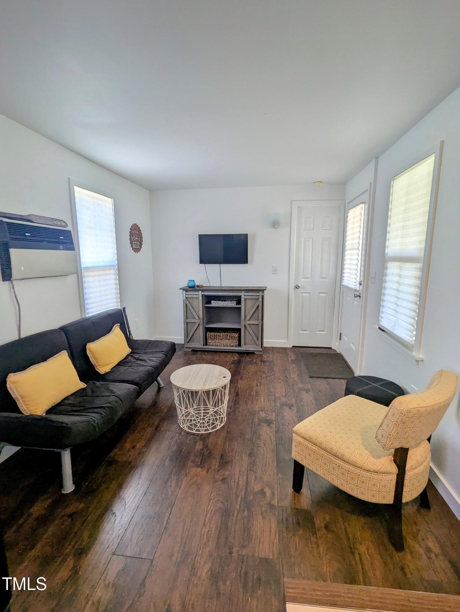 529 Flanagan Road Henderson, NC 27537 - Photo 10 of 38 a living room with furniture and a flat screen tv