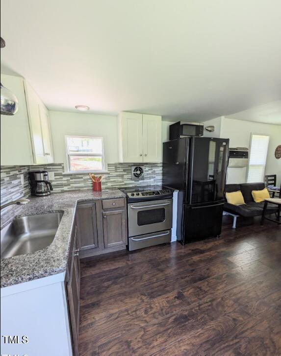529 Flanagan Road Henderson, NC 27537 - Photo 11 of 38 a kitchen with granite countertop a refrigerator and a sink