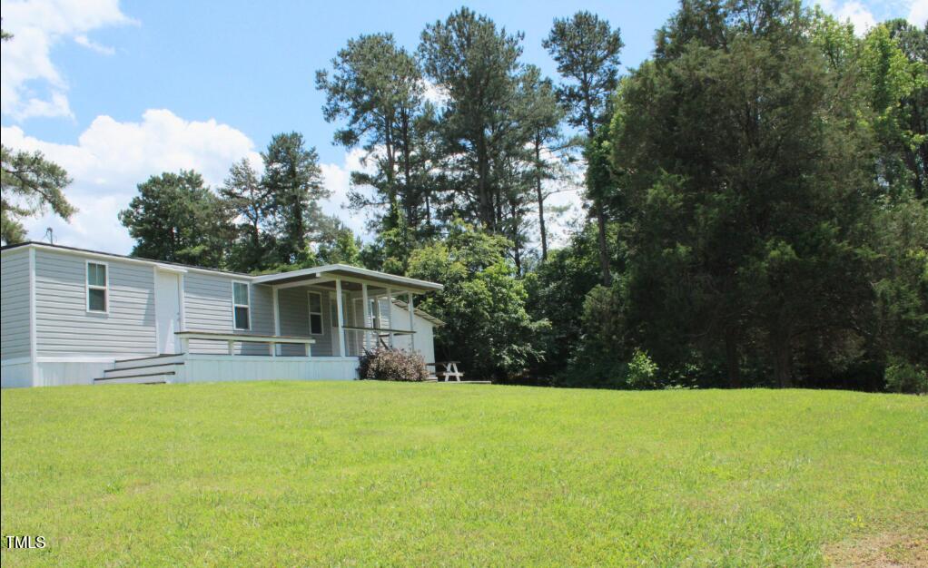529 Flanagan Road Henderson, NC 27537 - Photo 13 of 38 a view of a yard with a house and large tree