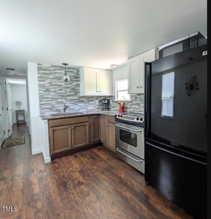 529 Flanagan Road Henderson, NC 27537 - Photo 15 of 38 a kitchen with stainless steel appliances kitchen island granite countertop a stove a sink dishwasher and a refrigerator
